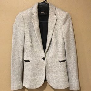 Gray blazer with faux leather accents.
